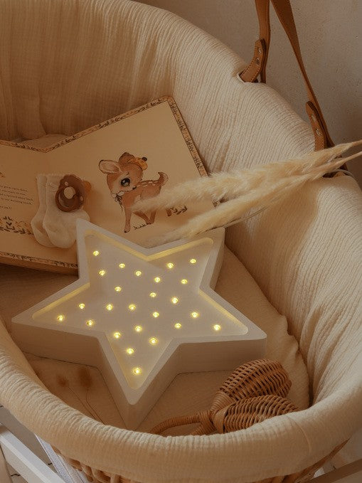softly glowing star lamp casting a warm, comforting light on a child's bedside table
