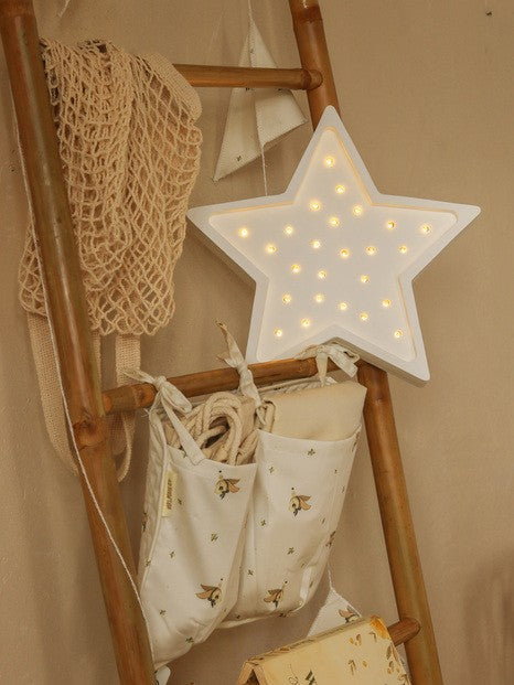 playful kid's hand turning the dial on a glowing handmade pine star lamp