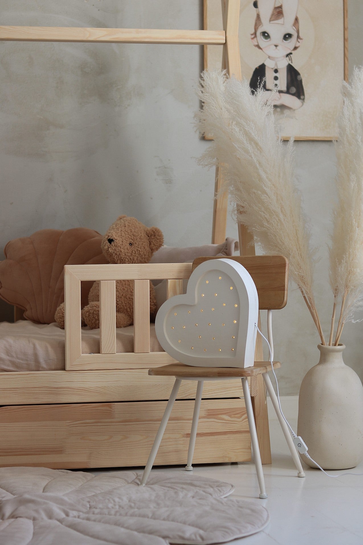 bold close-up of a solid pinewood heart lamp glowing warmly against a dark background