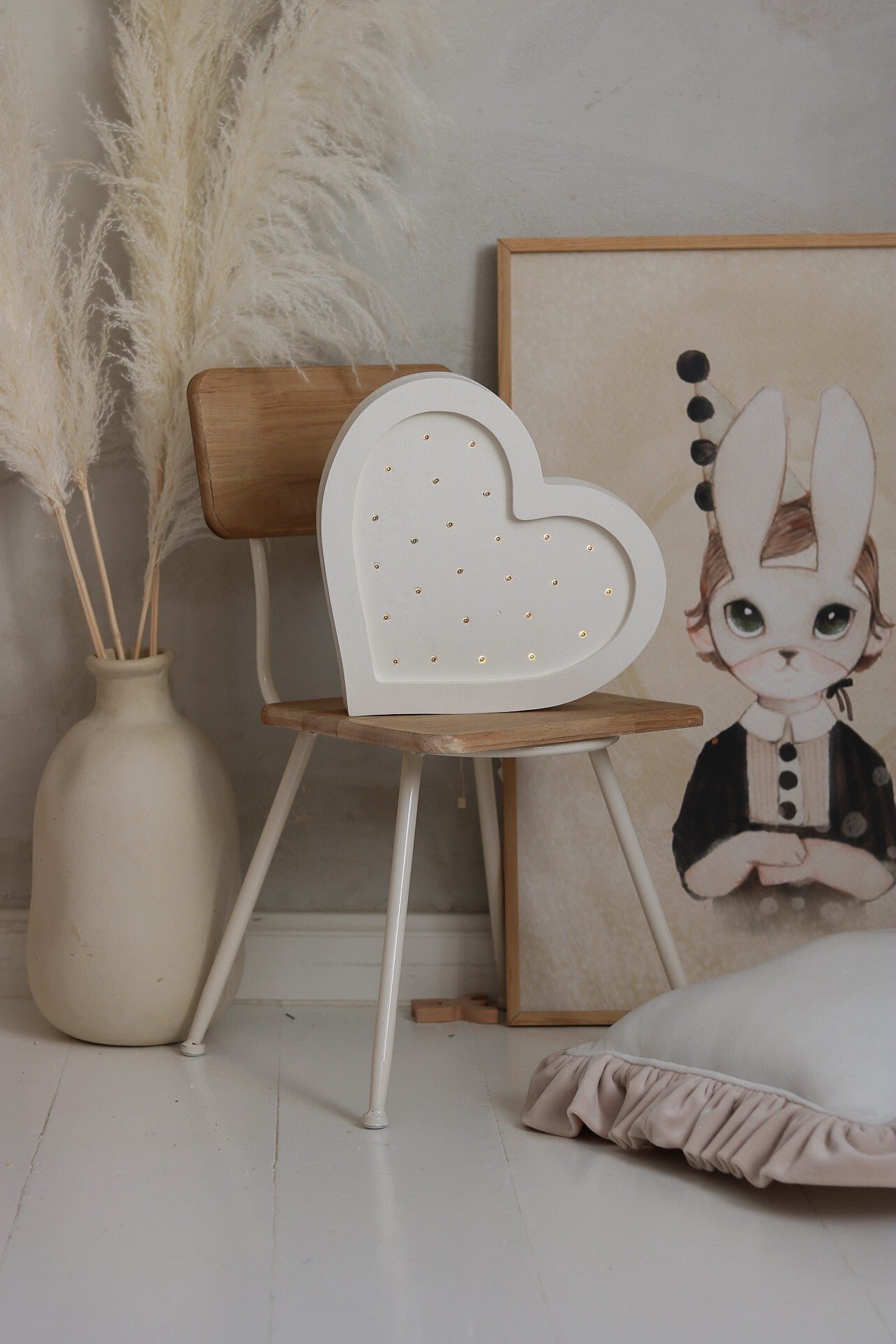 softly glowing heart lamp on a childs nightstand casting a warm cozy light