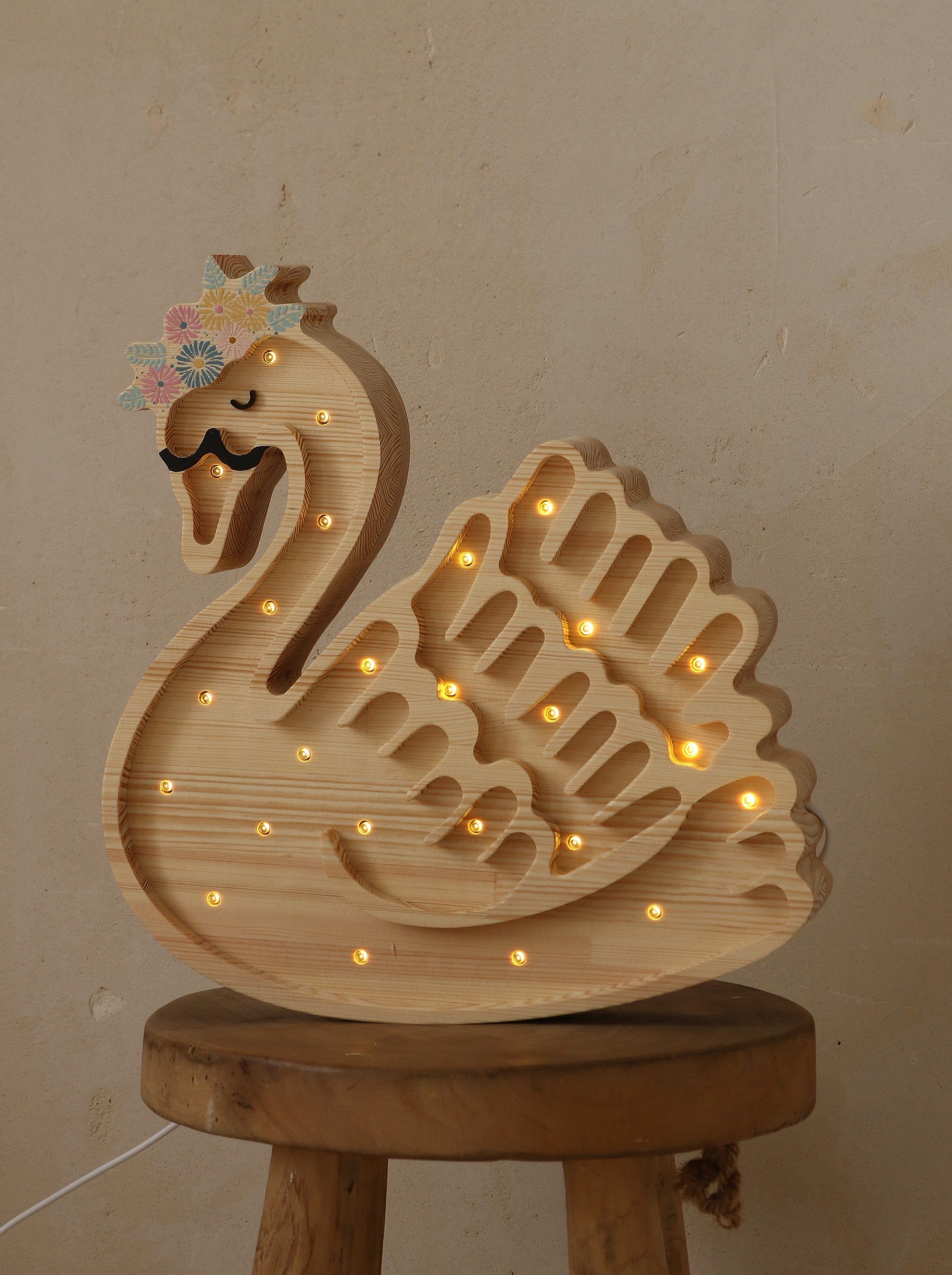 softly glowing swan lamp casting a warm, comforting light on a child's bedside table
