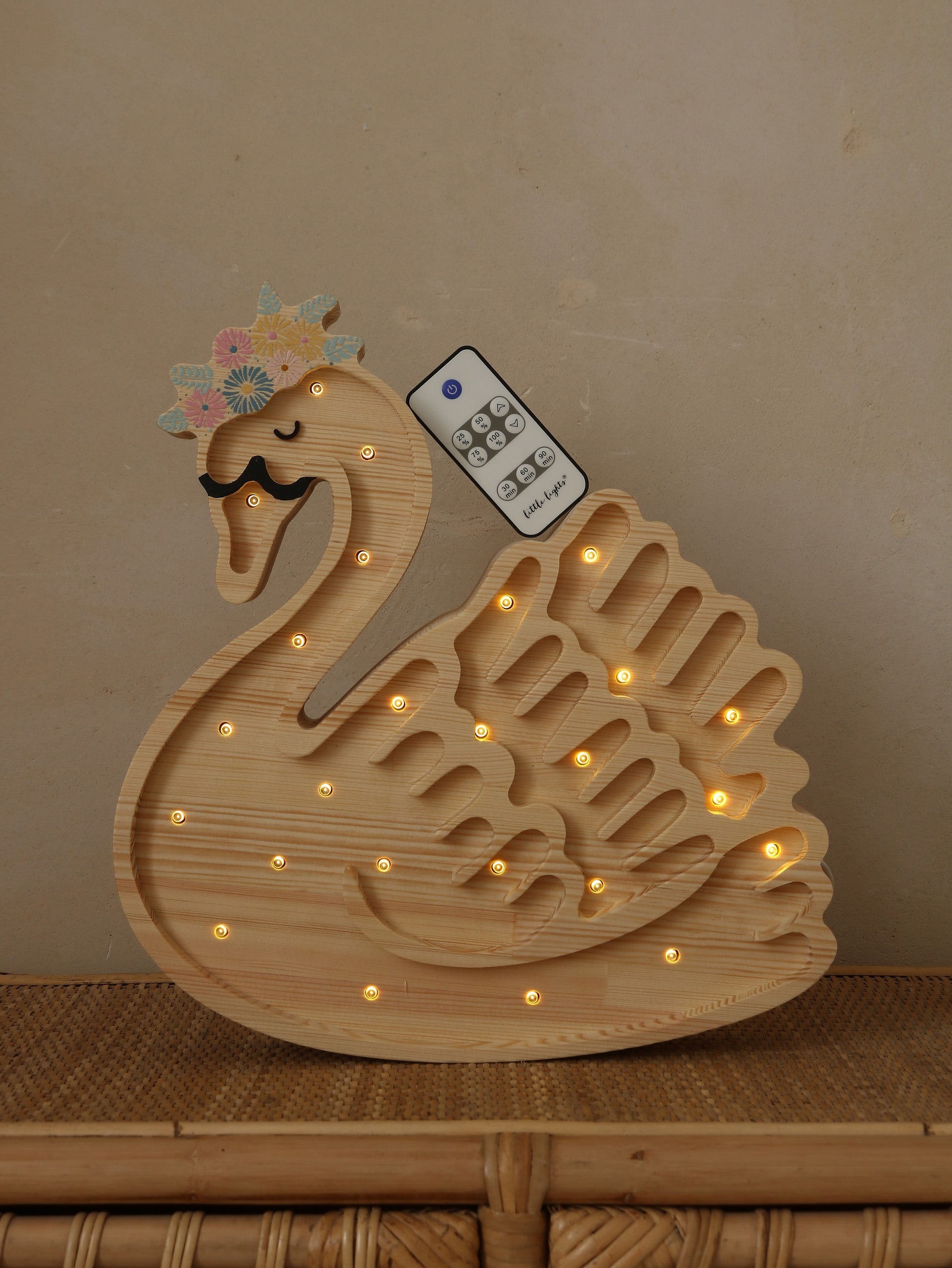 close-up of the swan lamp's handcrafted pine wood grain and soft glowing led light