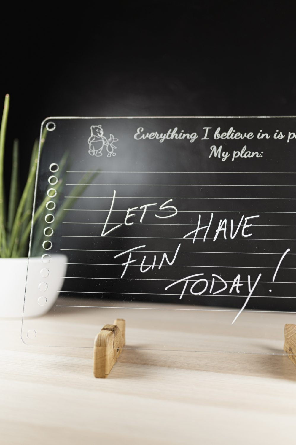 a playful toddler drawing on their luula acrylic daily planner with colorful markers