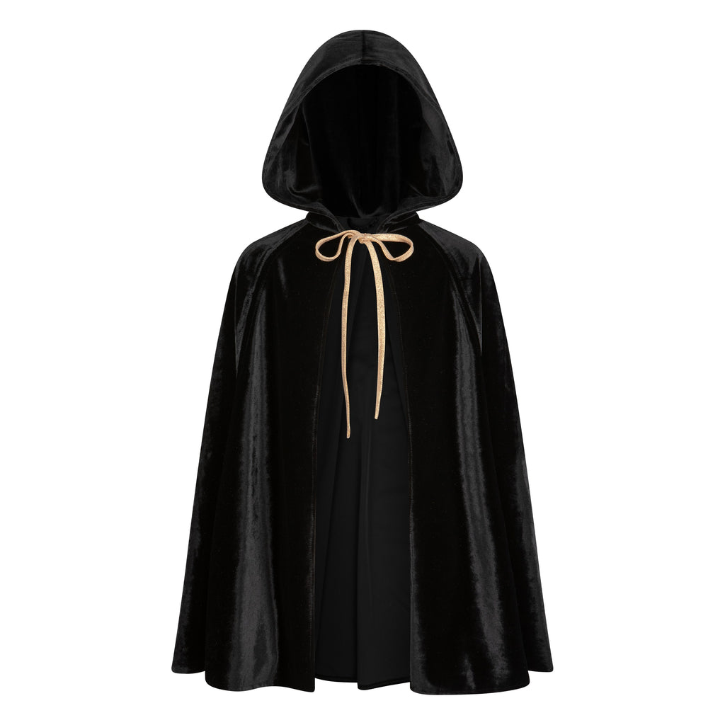 a child twirling in a playful black velour cape with hand holes, mid-spin during a fun backyard adventure