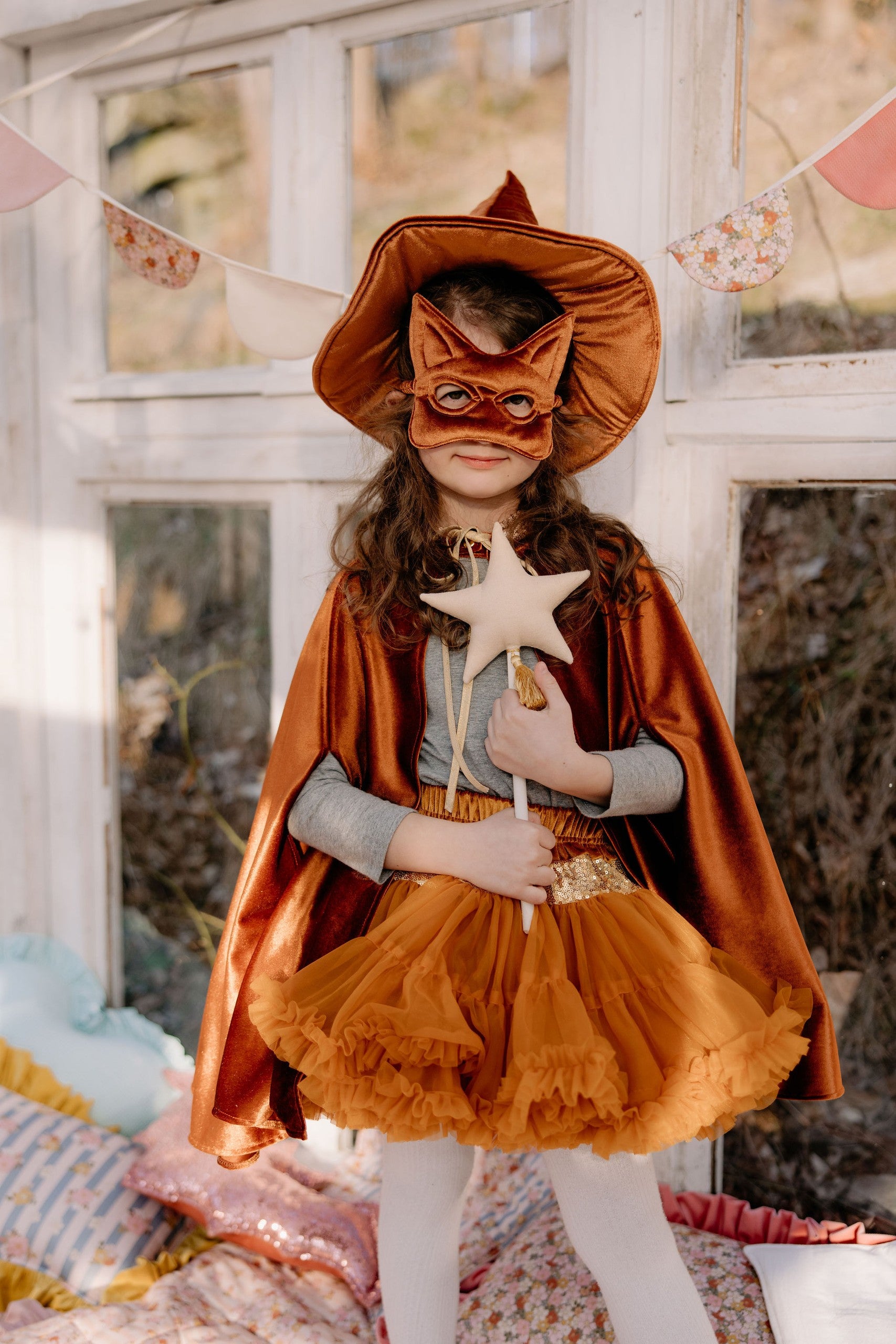 elegant handcrafted ginger velour cape with a deep hood, shown in a refined close-up