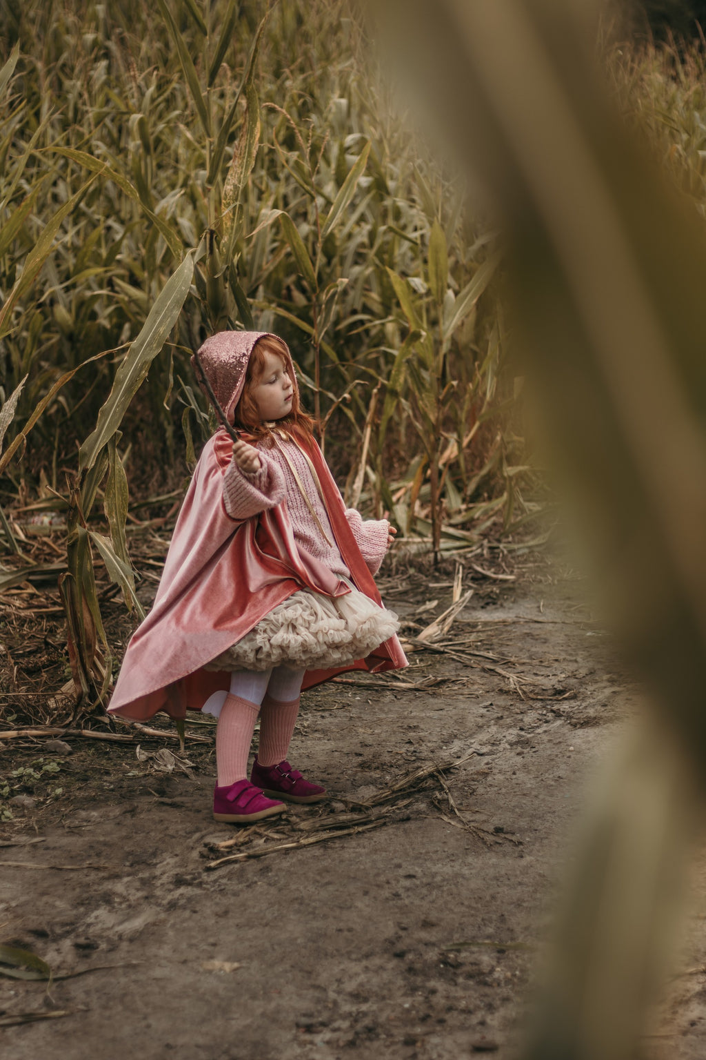 playful pink velour magic cape with hand holes, swirling in motion for fairy tale adventures