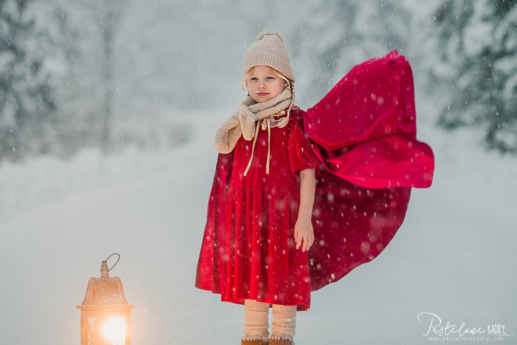 red riding hood cape twirling in a sunlit garden playtime
