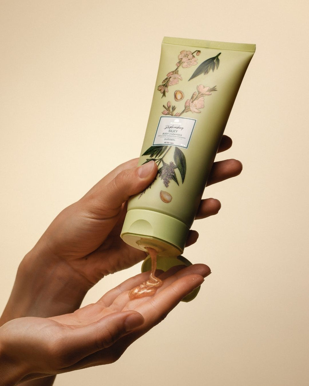 bold shot of magrada x lauren shimmering shower gel bottle with golden light