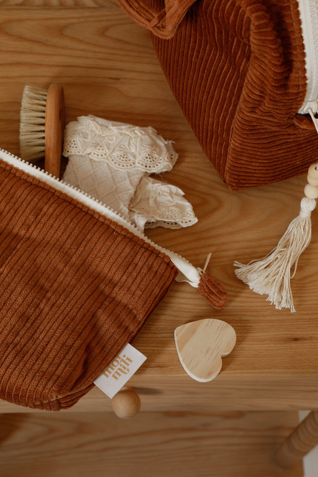 moi mili caramel makeup bag set of two on a rustic wooden table with warm morning light