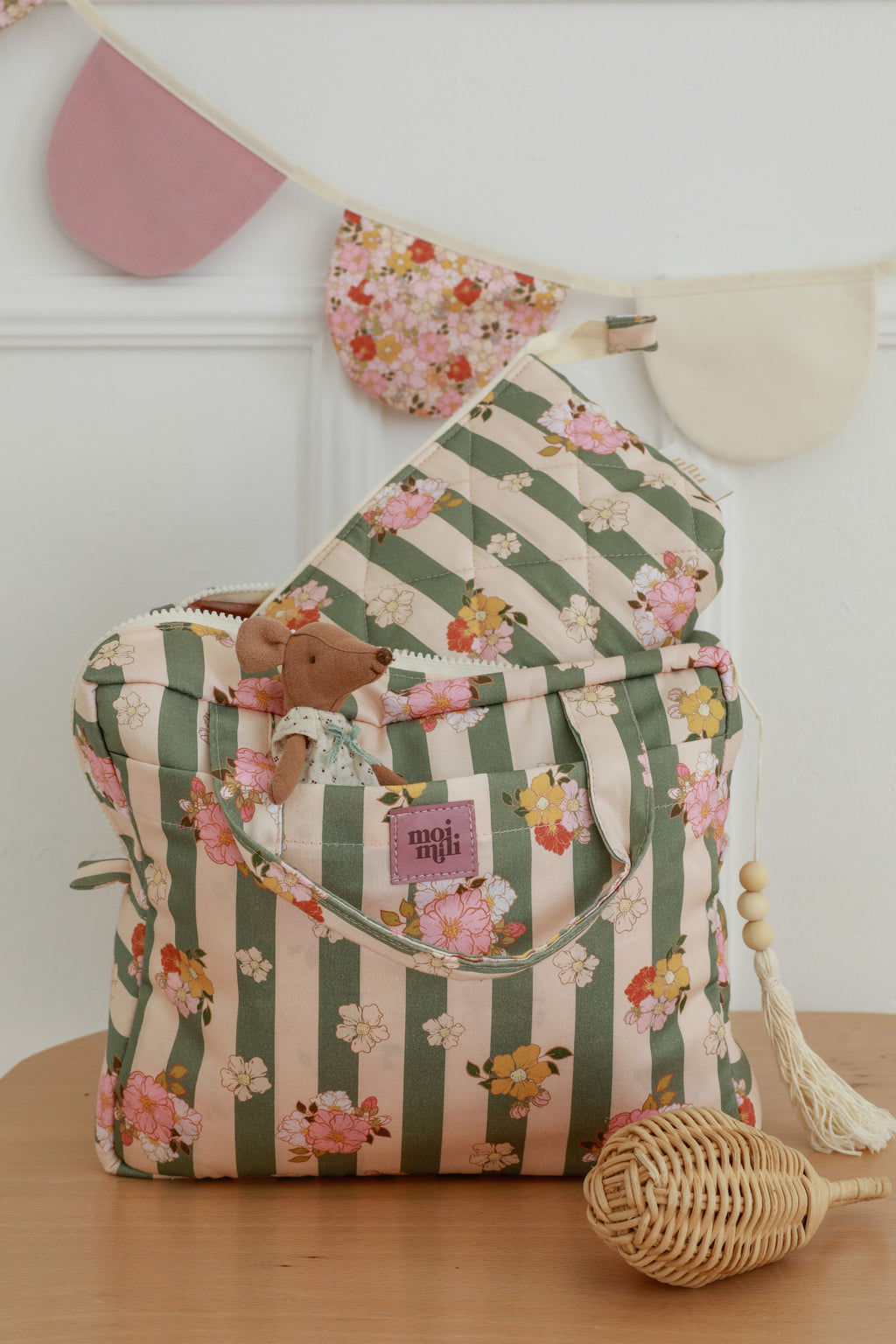 softly lit green striped cotton makeup bag open to reveal its inner waterproof pocket