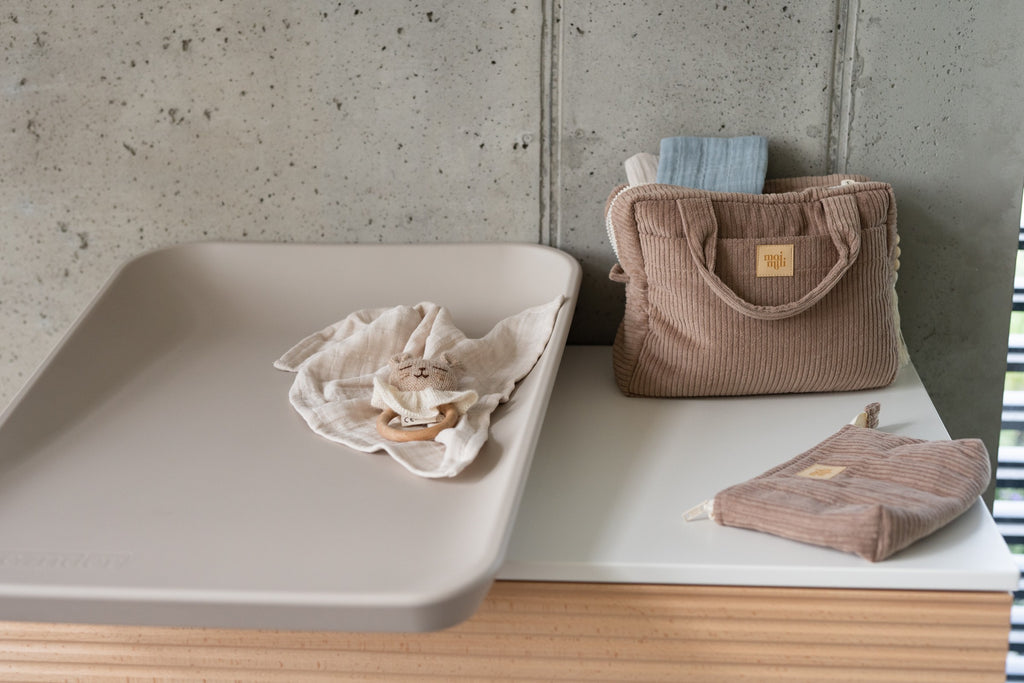 moi mili latte makeup bag set of two on a rustic wooden table, showcasing its functional and practical cotton design
