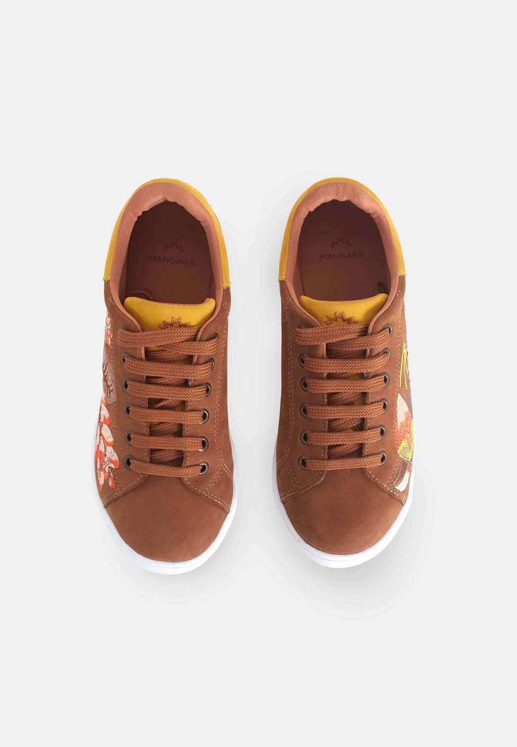 mangara womens brown suede sneakers with floral embroidery detail shot on a rustic wooden table