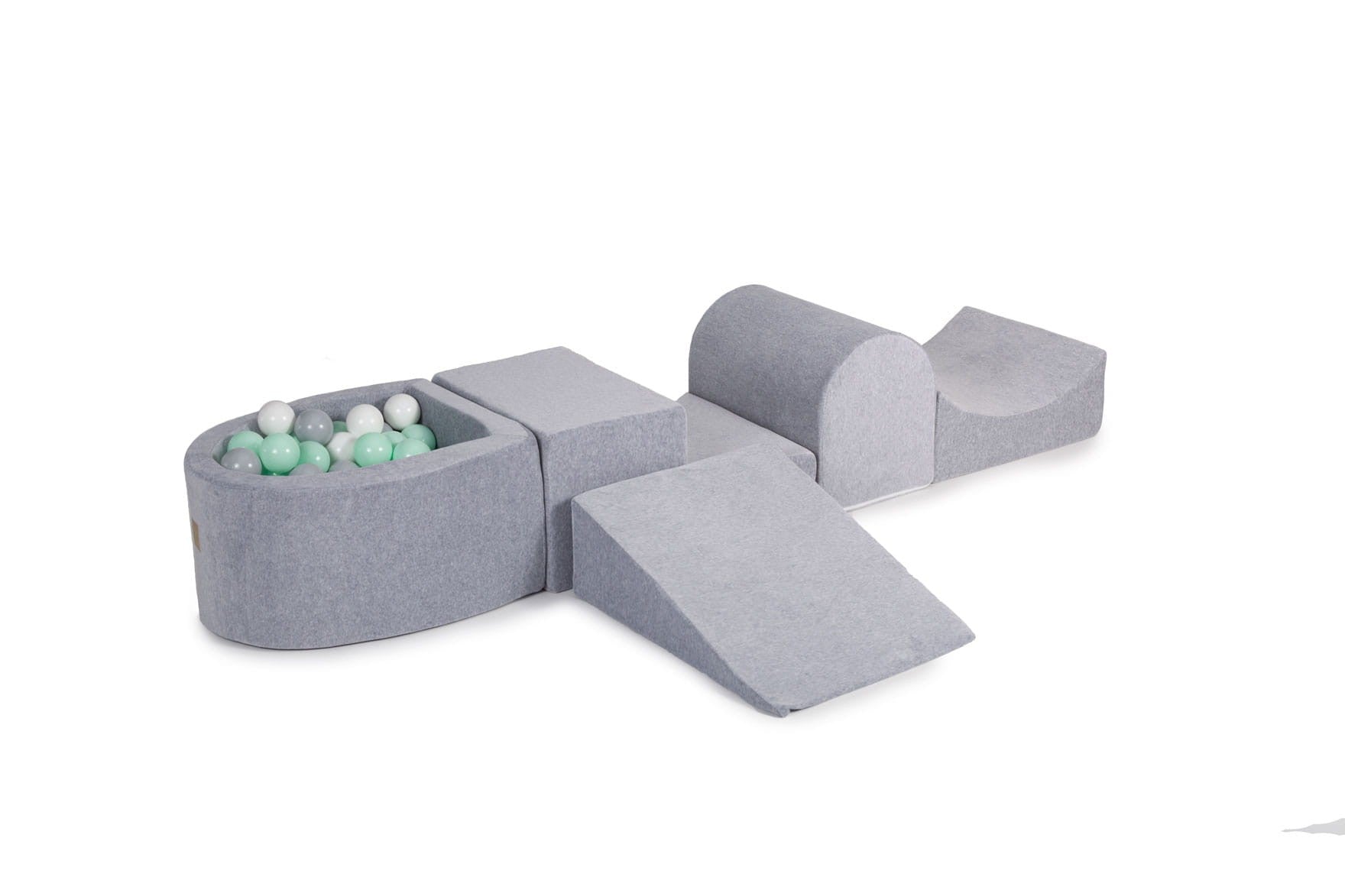 bold grey velvet soft play set with mint and white balls in dramatic studio lighting
