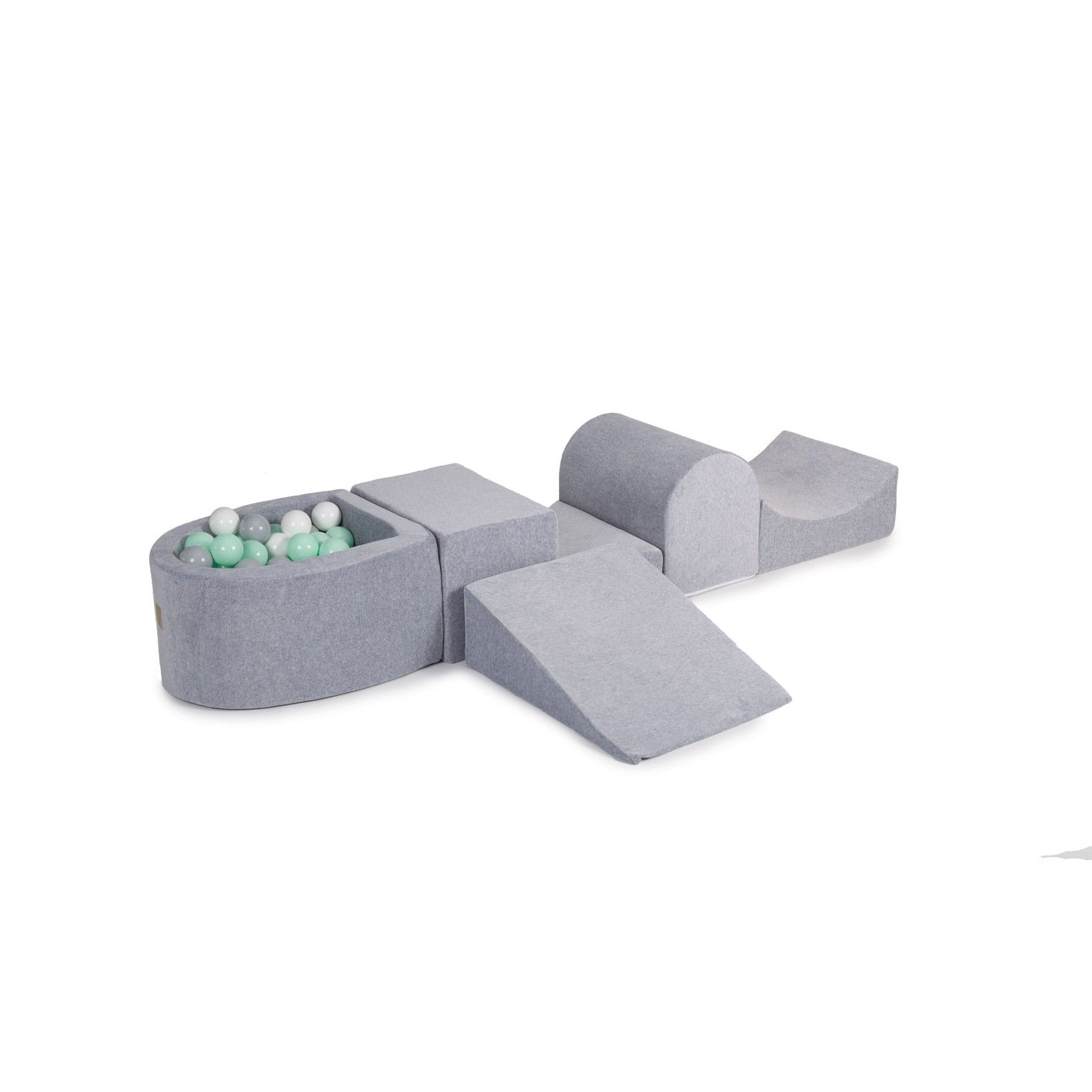 a soft grey velvet play set with a ball pit filled with mint and white balls in a cozy, softly lit nursery
