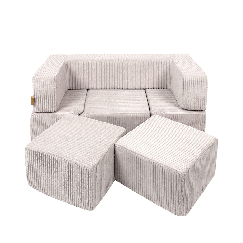 ecru modular play sofa pieces stacked in a minimalist room with soft morning light