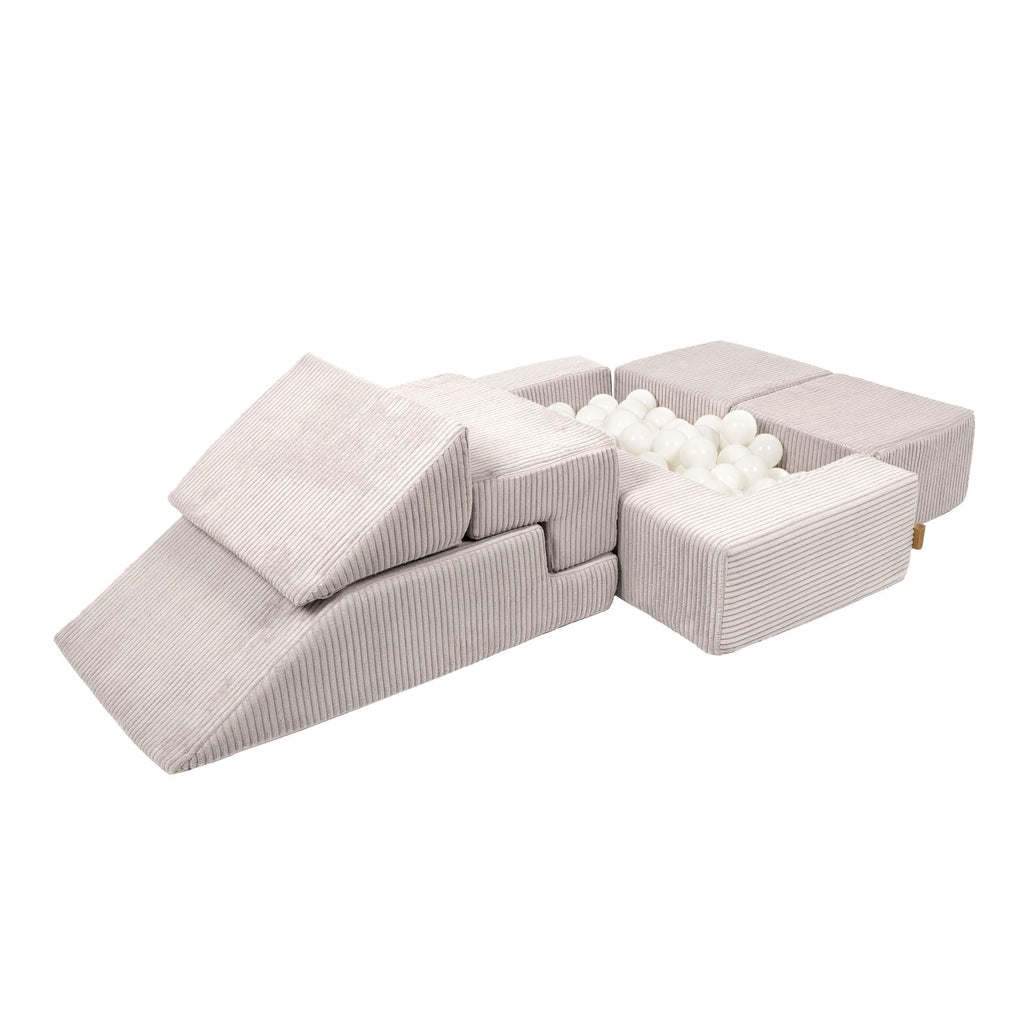 a soft ecru velvet play sofa arranged in a chic, minimalist living room for adults
