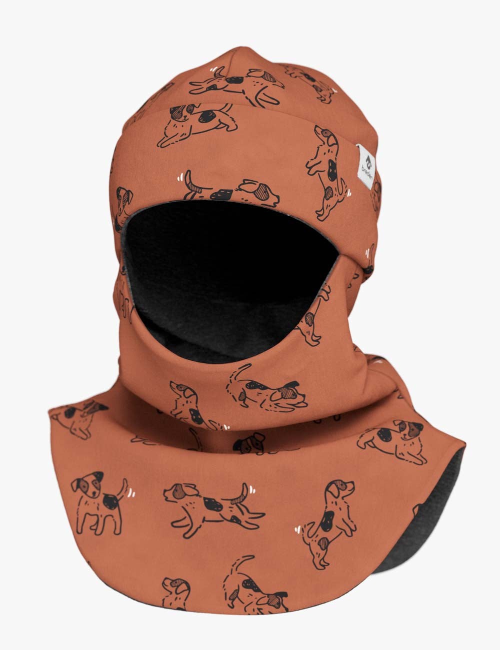 a child peeking playfully from a copper dogs merino balaclava in warm indoor light