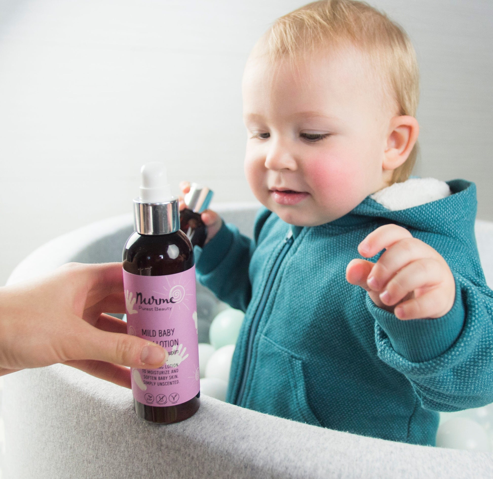 confident close-up of gentle baby lotion bottle with organic oils highlighted
