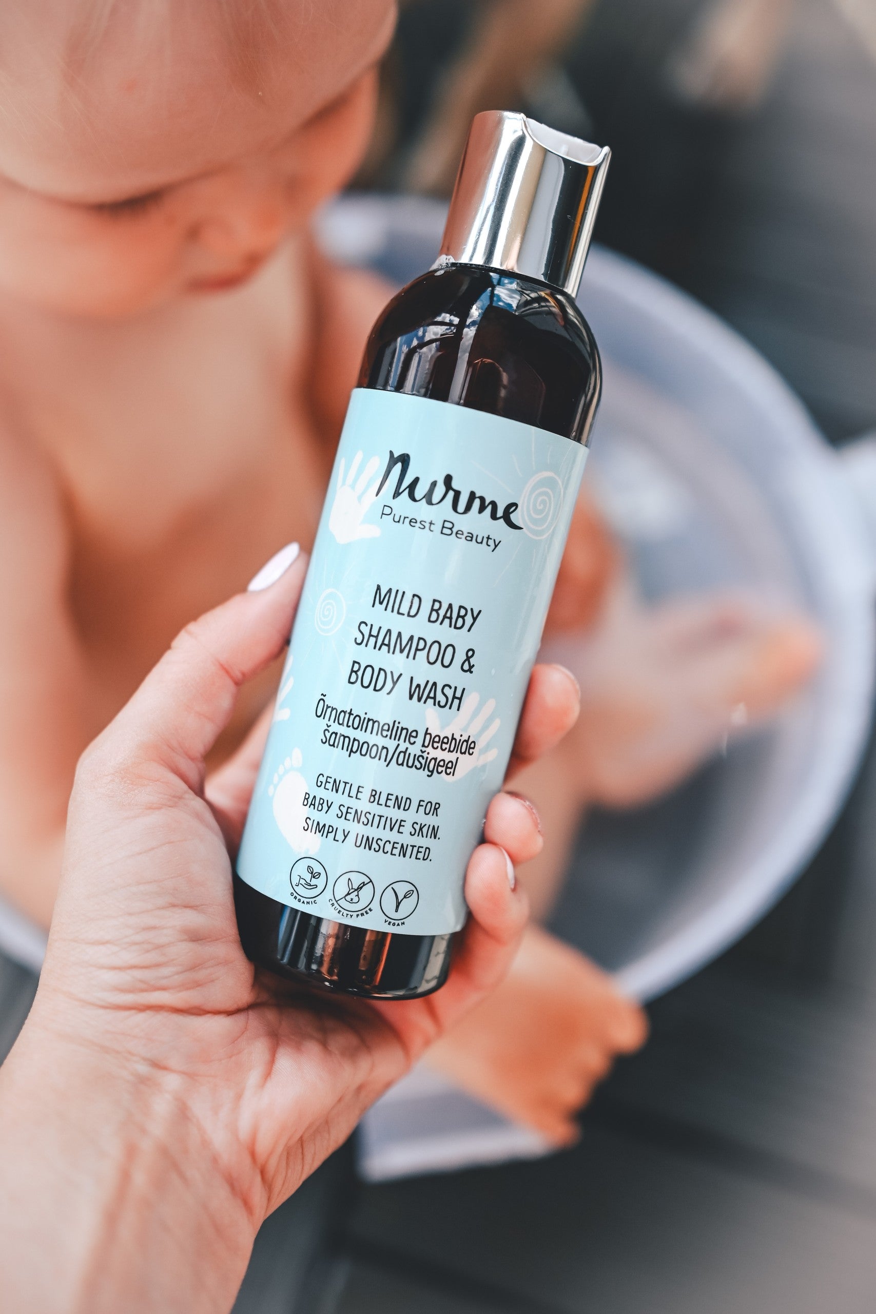 bold hero shot of nurme mild baby shampoo and body wash bottle with warm golden lighting