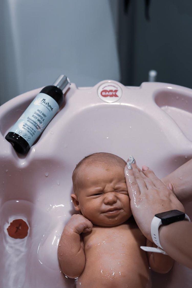 elegant nurme baby shampoo and body wash bottle with soft morning light on its minimalist design