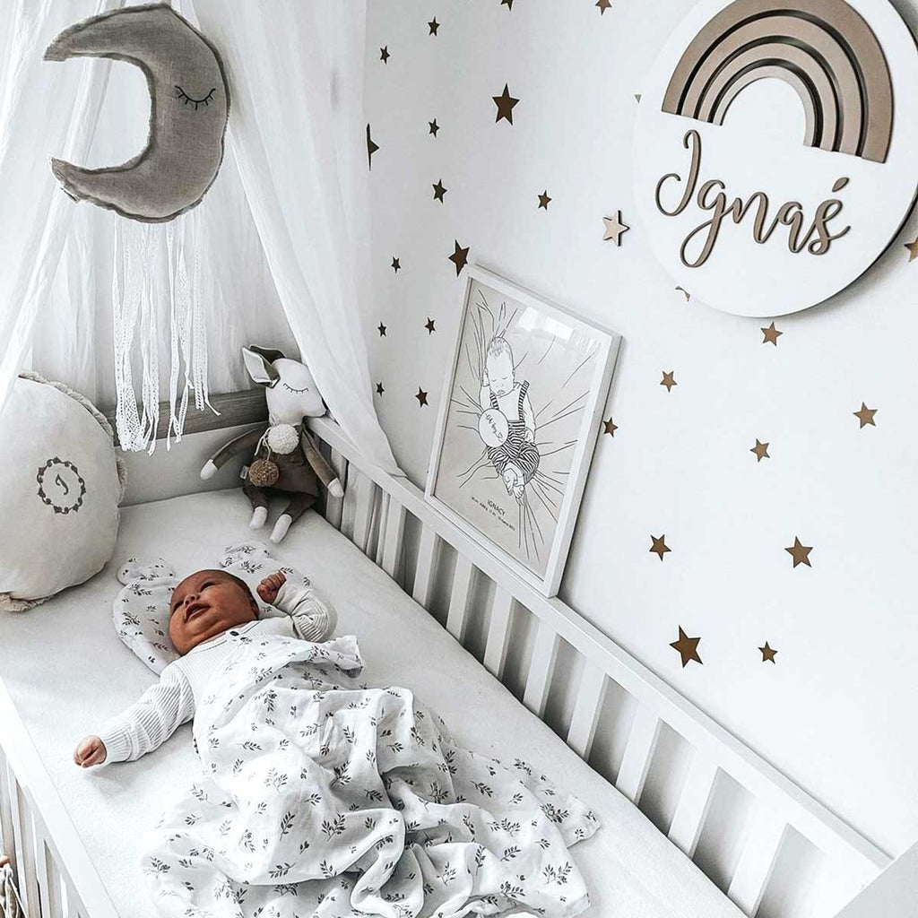 a soft arrangement of gold star stickers on a nursery wall in the gentle morning light