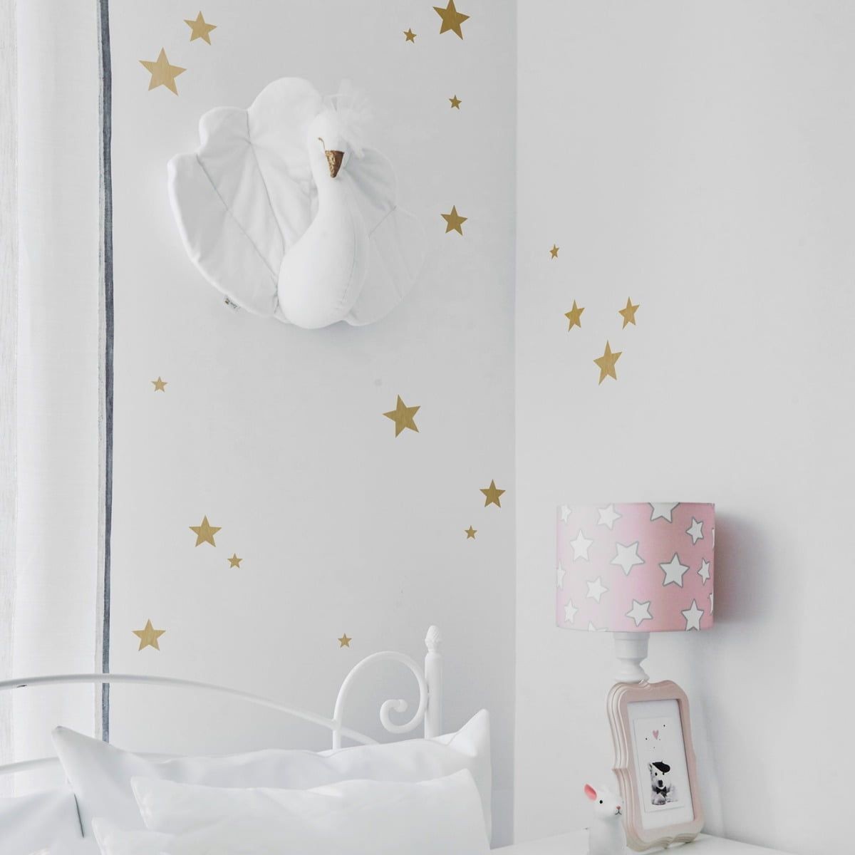 bold arrangement of gold star stickers in various sizes on a dark wall