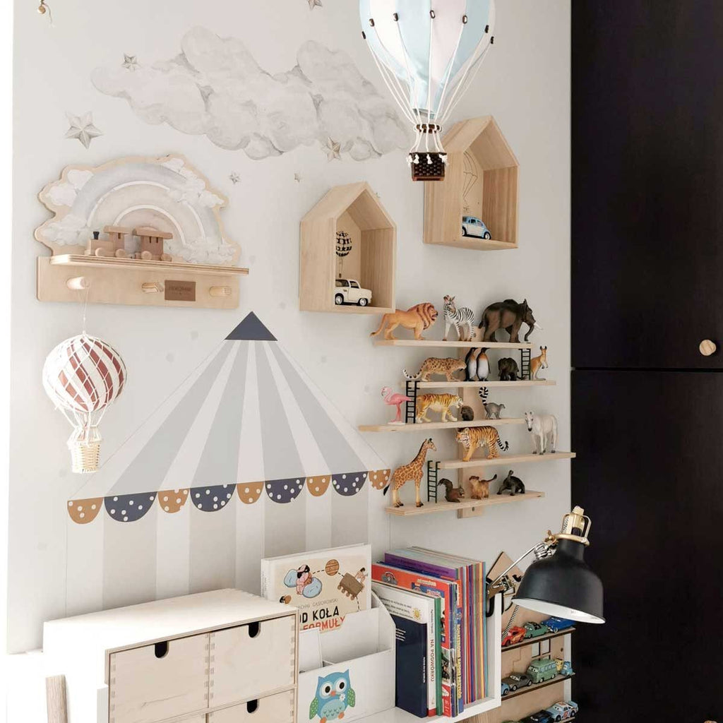 a playful blue rainbow wall shelf with a colorful dinosaur sticker, shown in a bright kids room with soft morning light