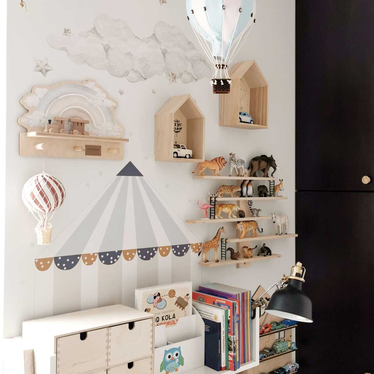 a playful blue rainbow wall shelf with a colorful dinosaur sticker, shown in a bright kids room with soft morning light