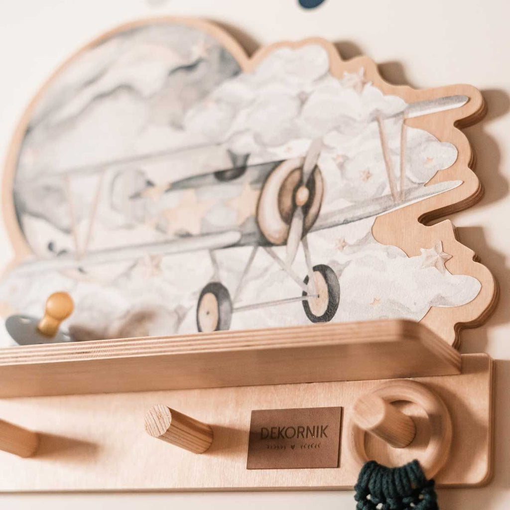 playful dinosaur wall shelf in a sunny kids room with a toy hanging on a peg