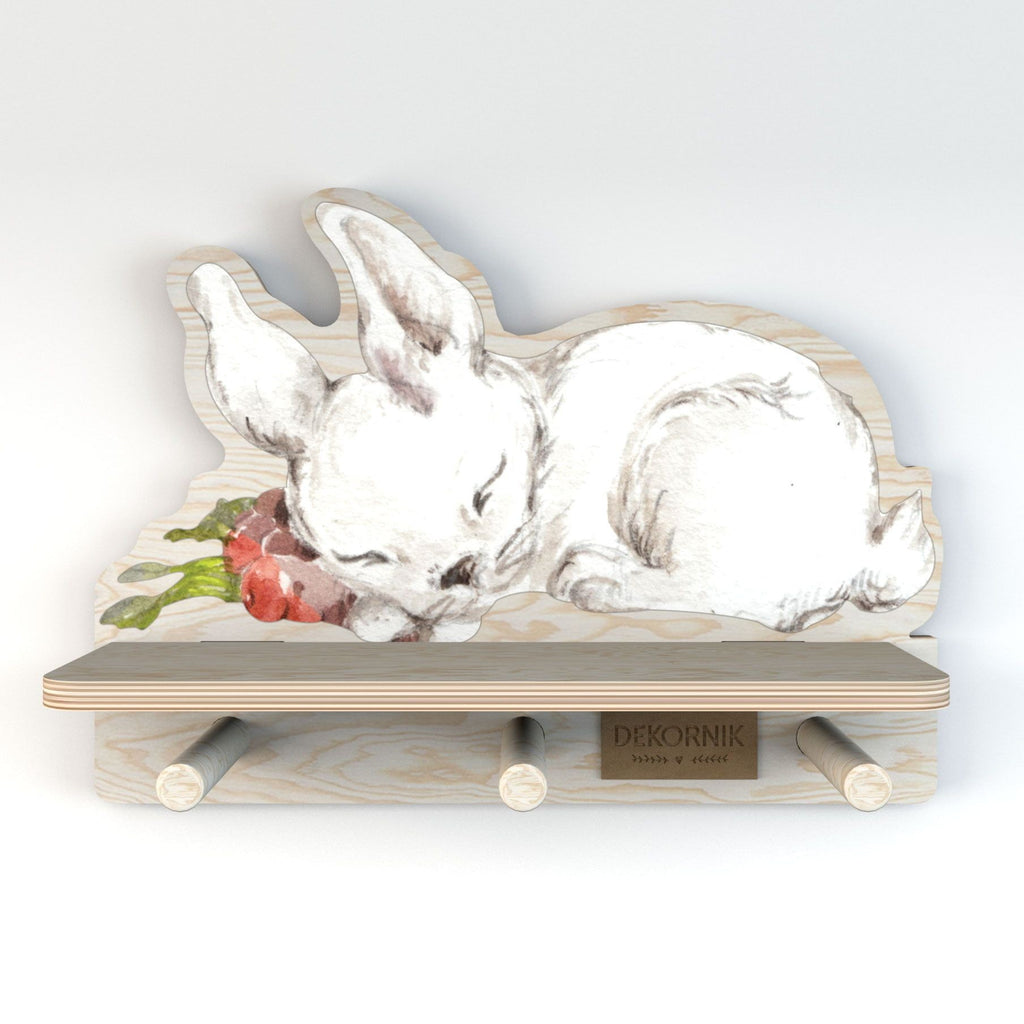 a playful rabbit mini wall shelf with three pegs for hanging small items in a bright kids room