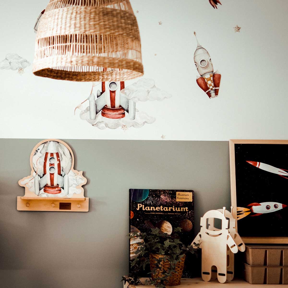 a rocketship mini wall shelf with a colorful dinosaur, shown in a bright kids room with morning light