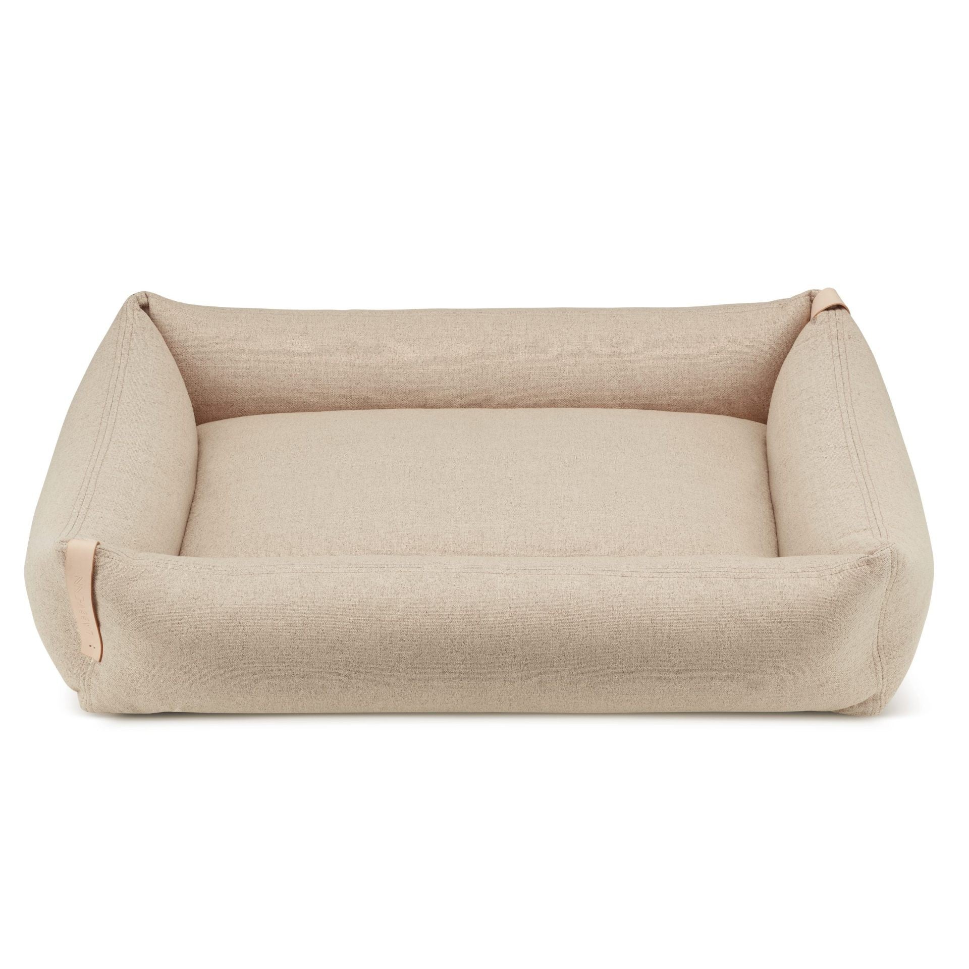 bold sand-colored moe dog bed with a stylish leather belt in a modern living room