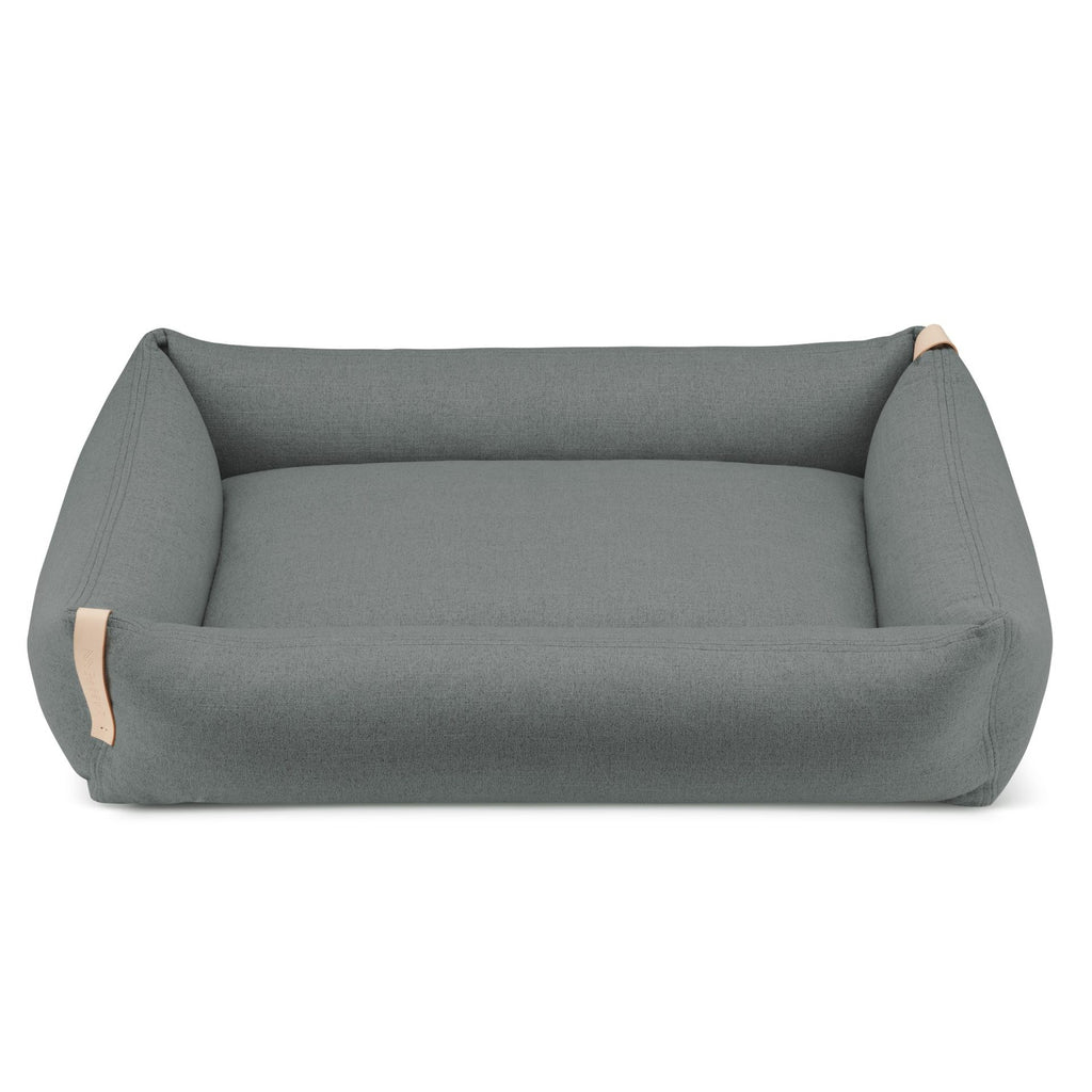 a soft anthracite grey dog bed with a cozy cotton inlett and a stylish leather belt detail