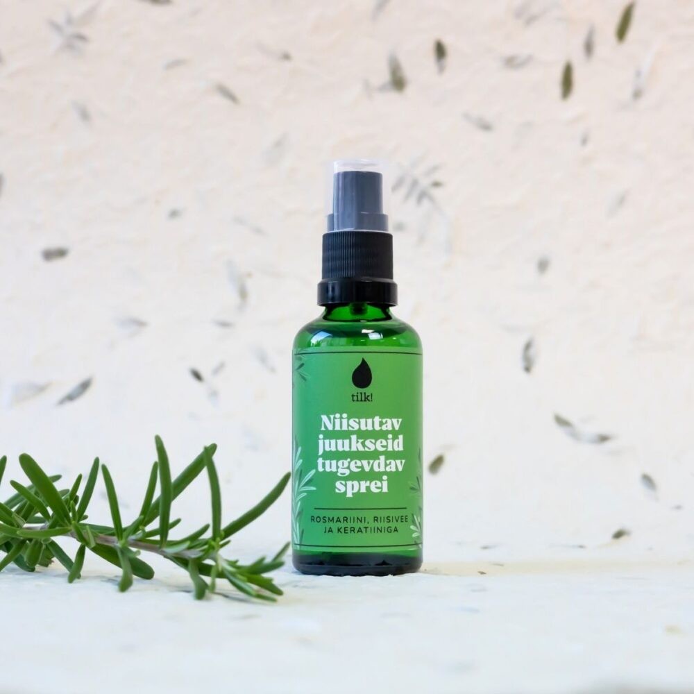 confident woman holding moisturizing hair spray with bold, sunlit backdrop