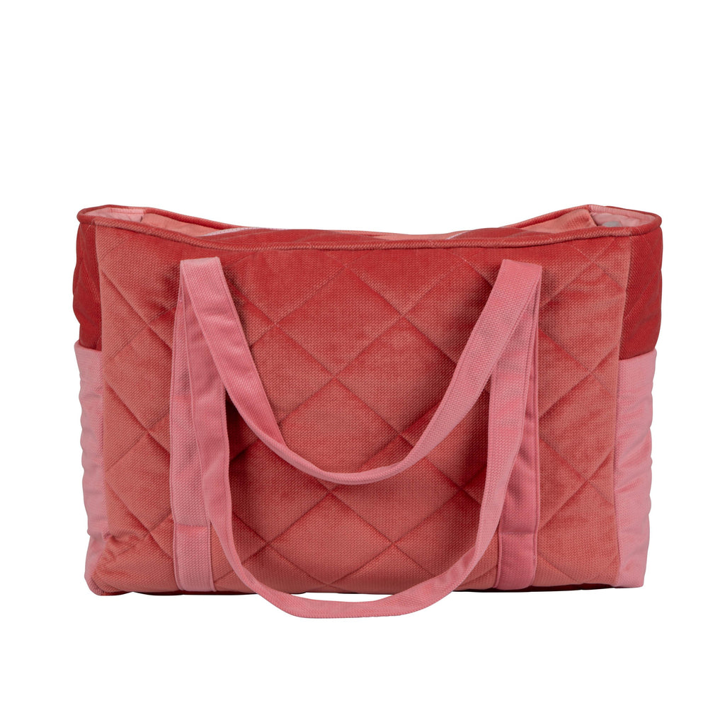 soft pink velvet mom bag with cozy morning light on its adjustable strap and organized pockets