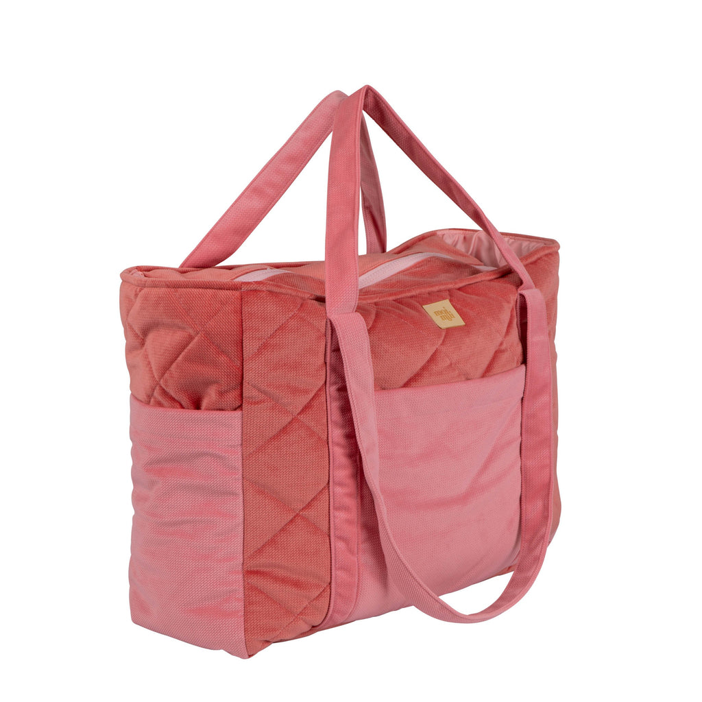confident mom modeling the candy pink weekender bag, showcasing its chic design and spacious interior