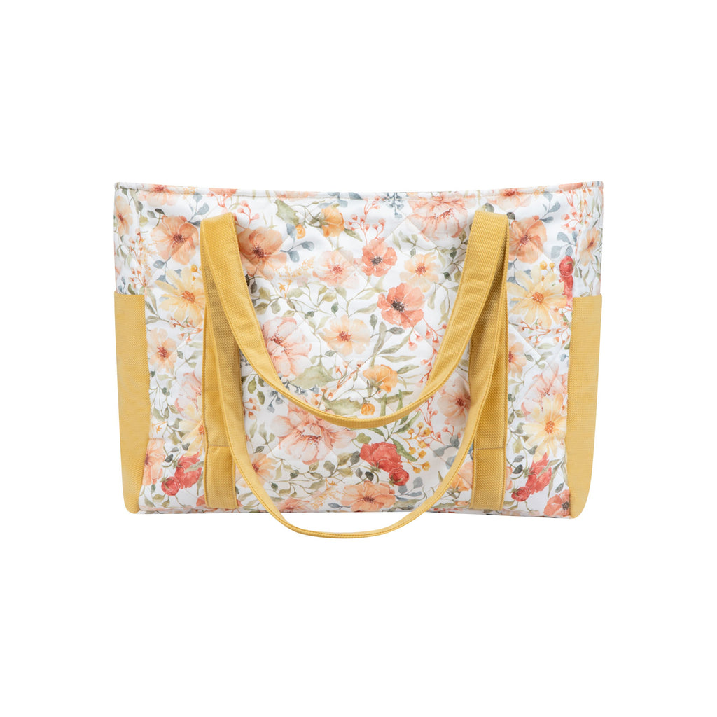 bold floral weekender bag with multiple pockets open on a city street