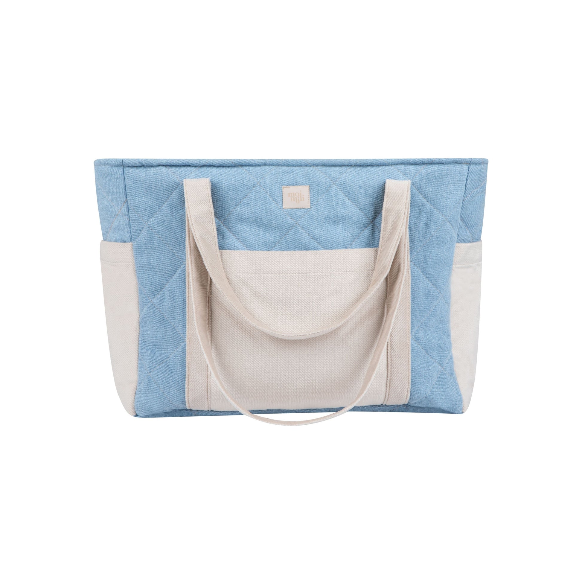 side view of a chic denim weekender bag on a park bench, showcasing its spacious interior and smart pocket organization