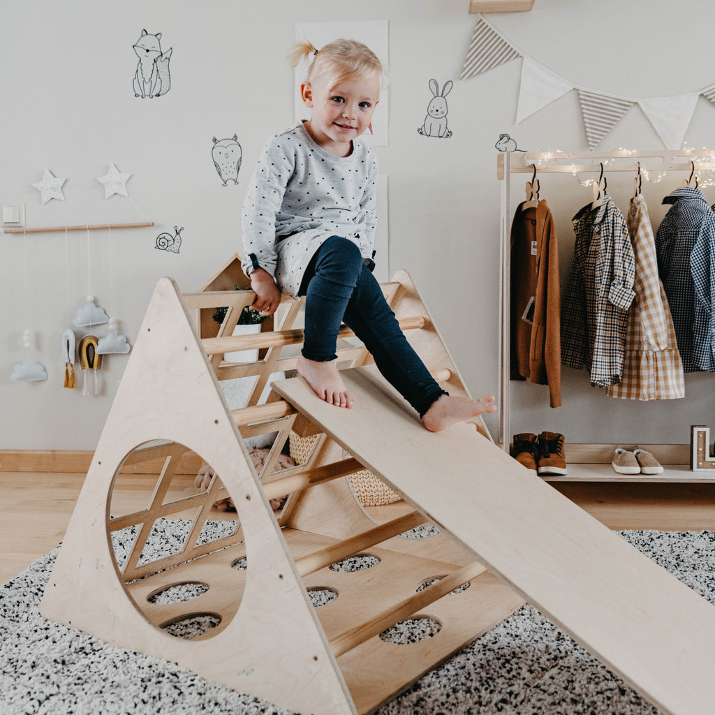a soft-lit view of the montessori climber with ramp, inviting quiet and cozy play in a nursery corner
