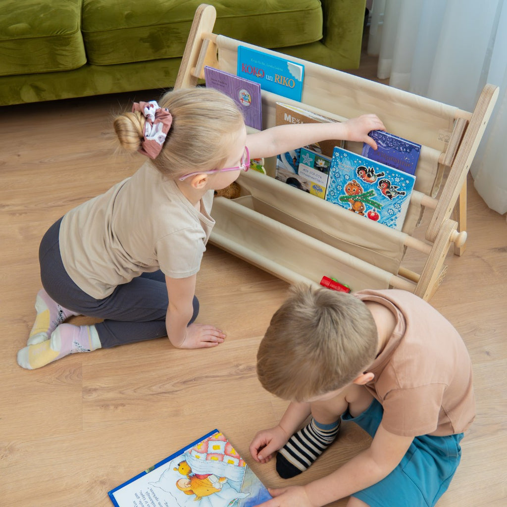 a soft cotton bookshelf attachment for a play frame, displaying colorful children's books in a cozy, sunlit nursery corner