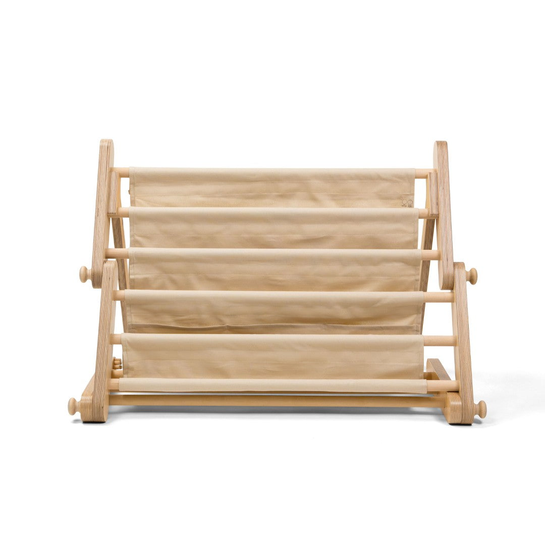 montessori bookshelf attachment secured to a play frame with books facing outwards for easy selection