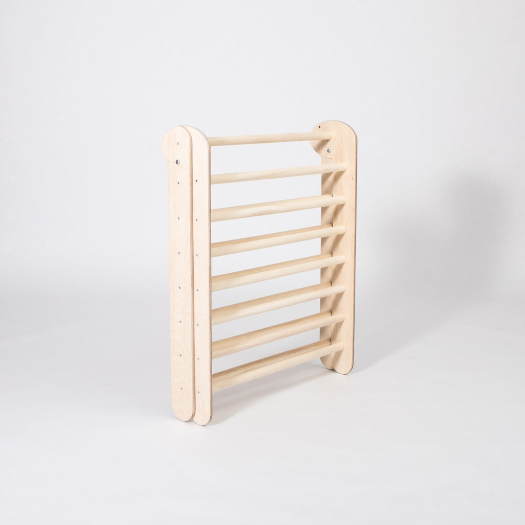 montessori climbing triangle folded for compact storage in a modern nursery