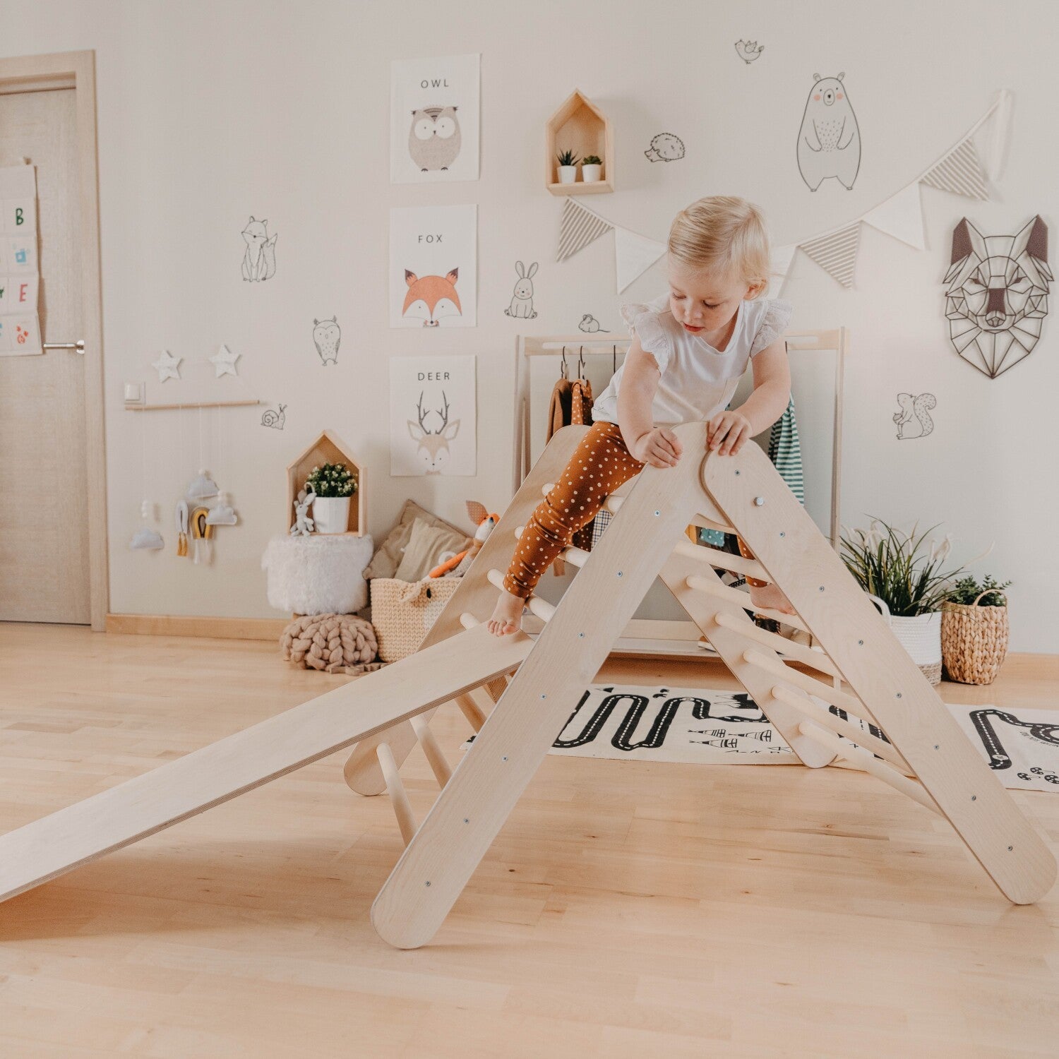 soft-lit montessori climbing triangle with ramp, inviting toddlers to explore in a cozy home setting