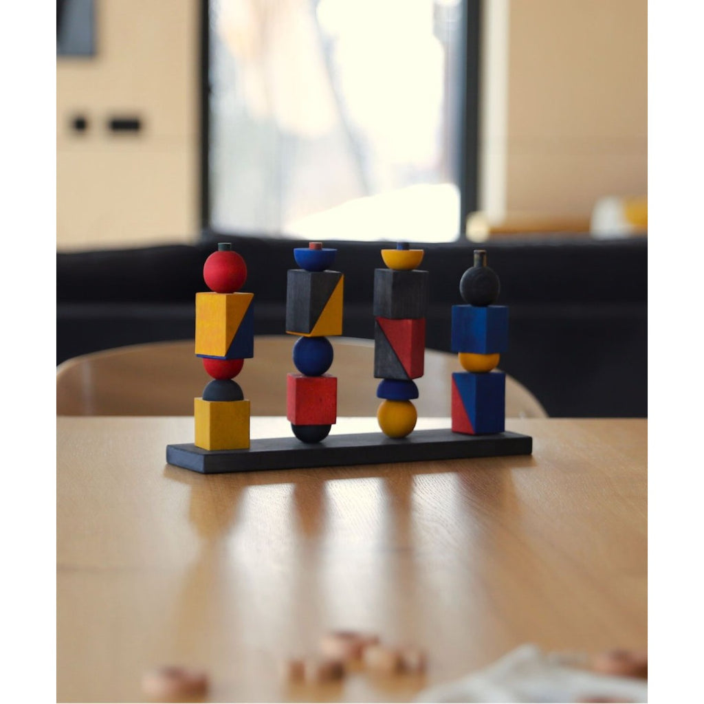 elegant wooden stacking toy with bauhaus-inspired geometric shapes, arranged in a minimalist composition