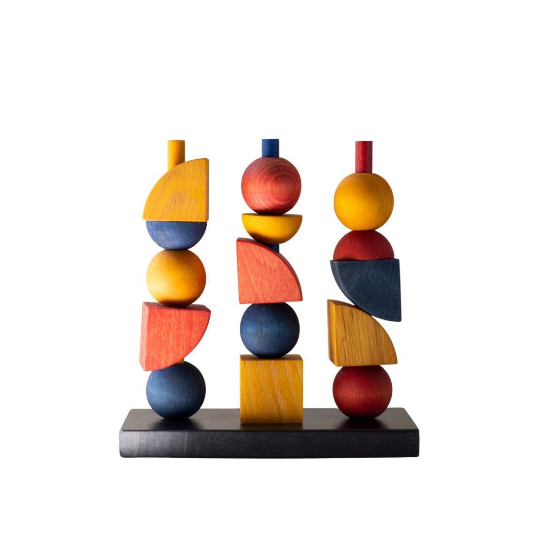a close-up side view of the wooden stacking toy showing the practical fit of geometric fence pieces