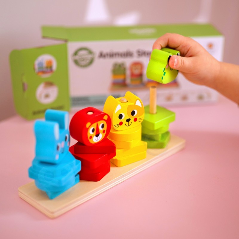 a child's hands arranging colorful wooden animal blocks on the pyramid base
