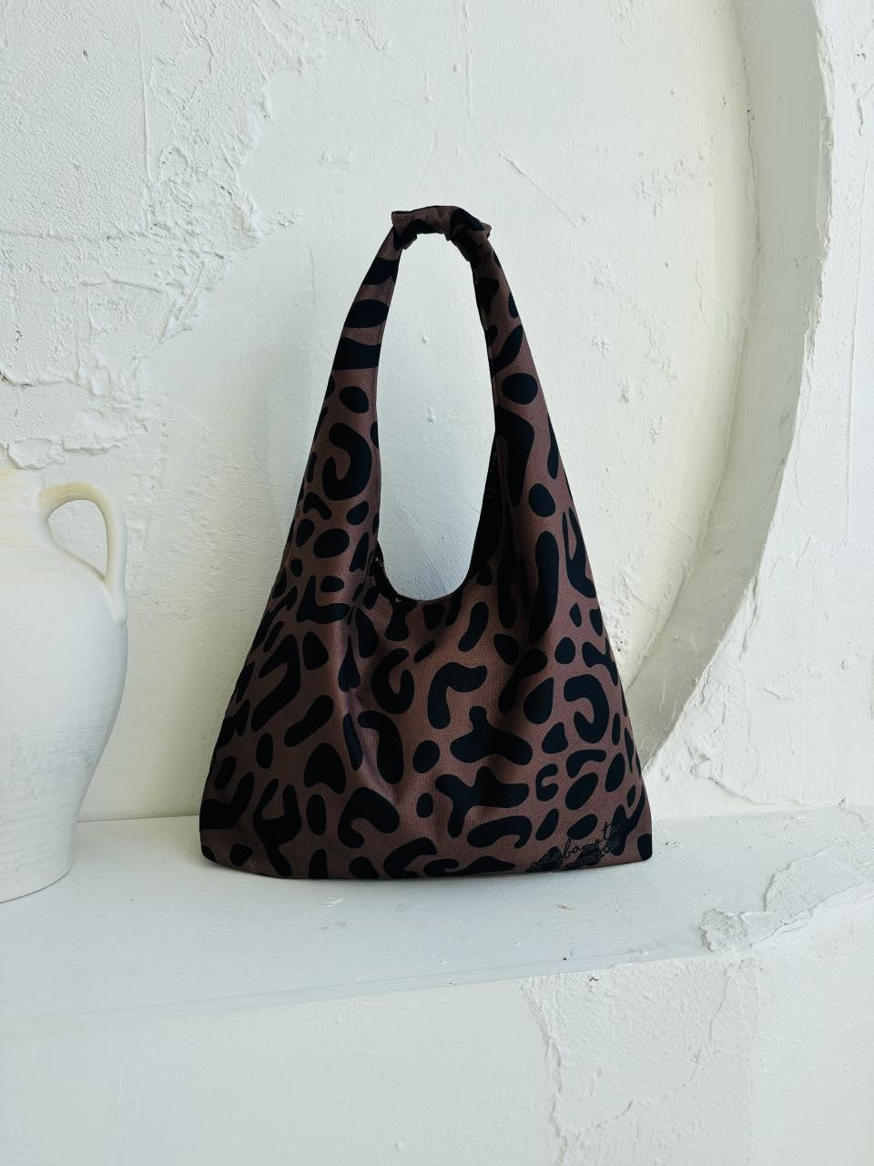 functional leopard print moon bag with interior zippered pocket and spacious design