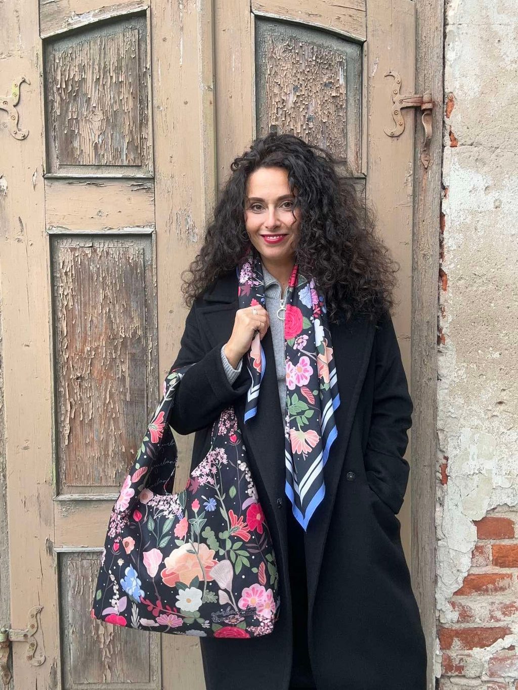 bold statement moon bag with metallic closure against a stark studio background