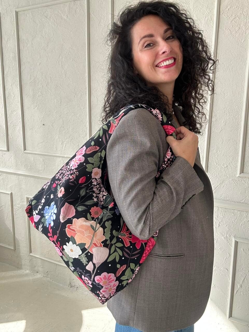 playful summer night moon bag with a fun, curly pattern held by a woman outdoors