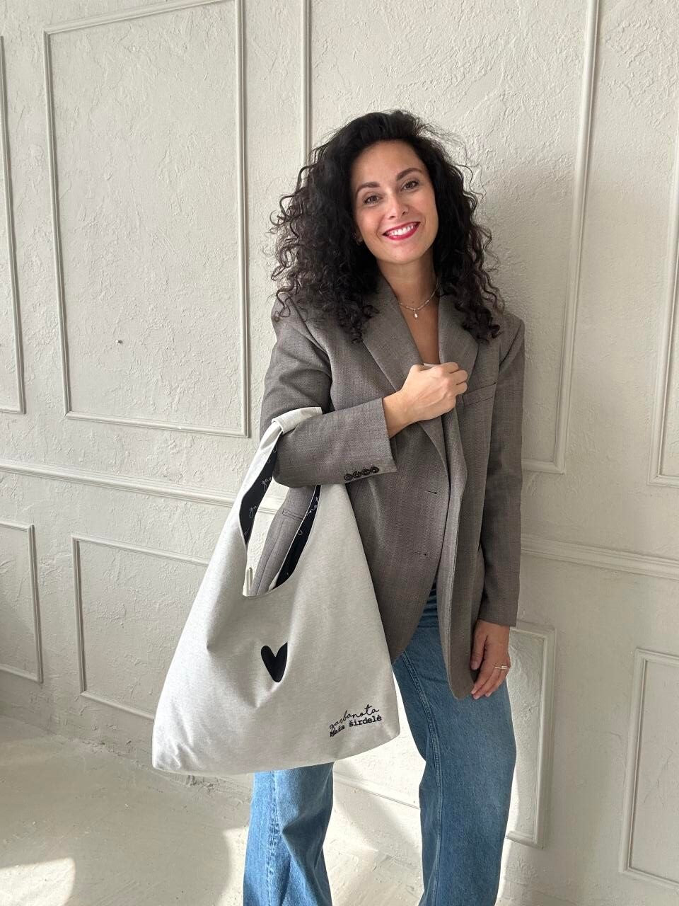 bold white moon bag heart held confidently against a dark backdrop